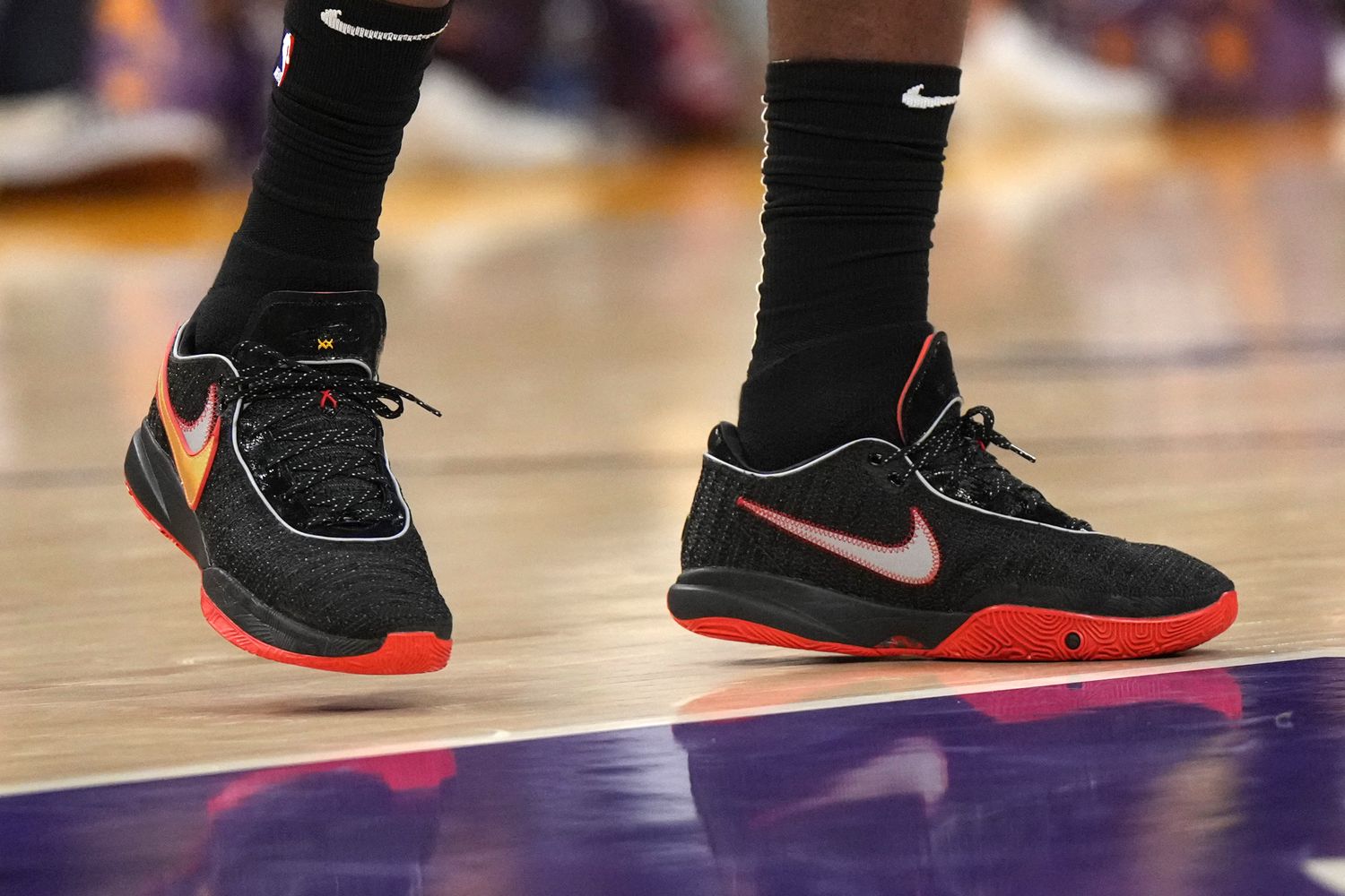 View of LeBron James' black and red Nike shoes.